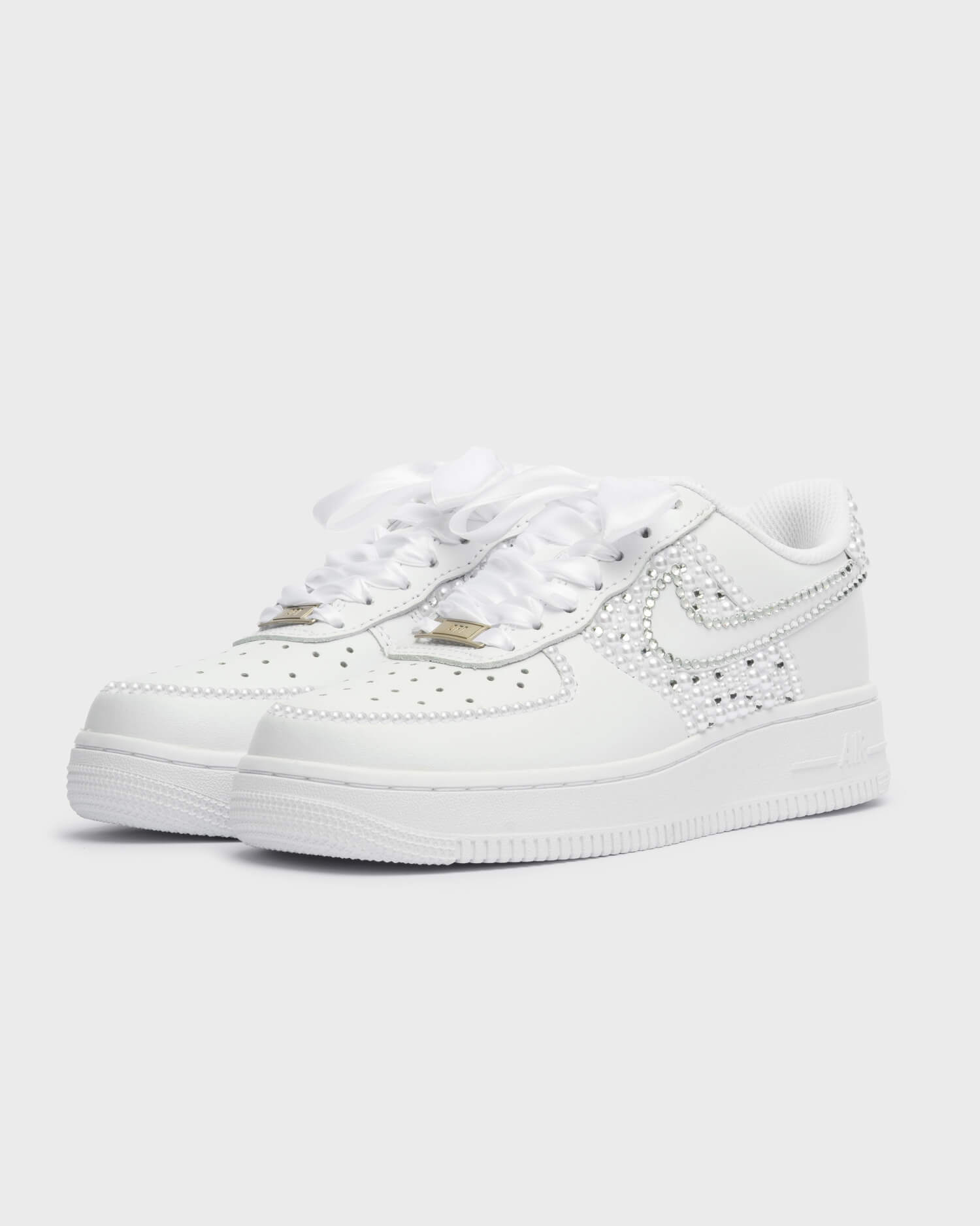 Custom white Air Force 1 wedding sneakers with pearl and rhinestone swoosh and toe detail, handmade bridal shoes with satin laces.