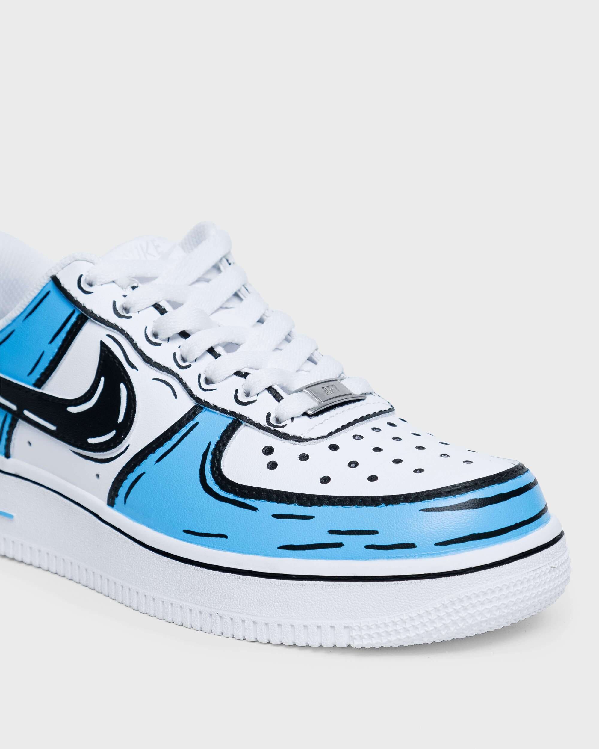 Close-up of hand-painted custom Air Force 1 sneaker with blue cartoon-style details.