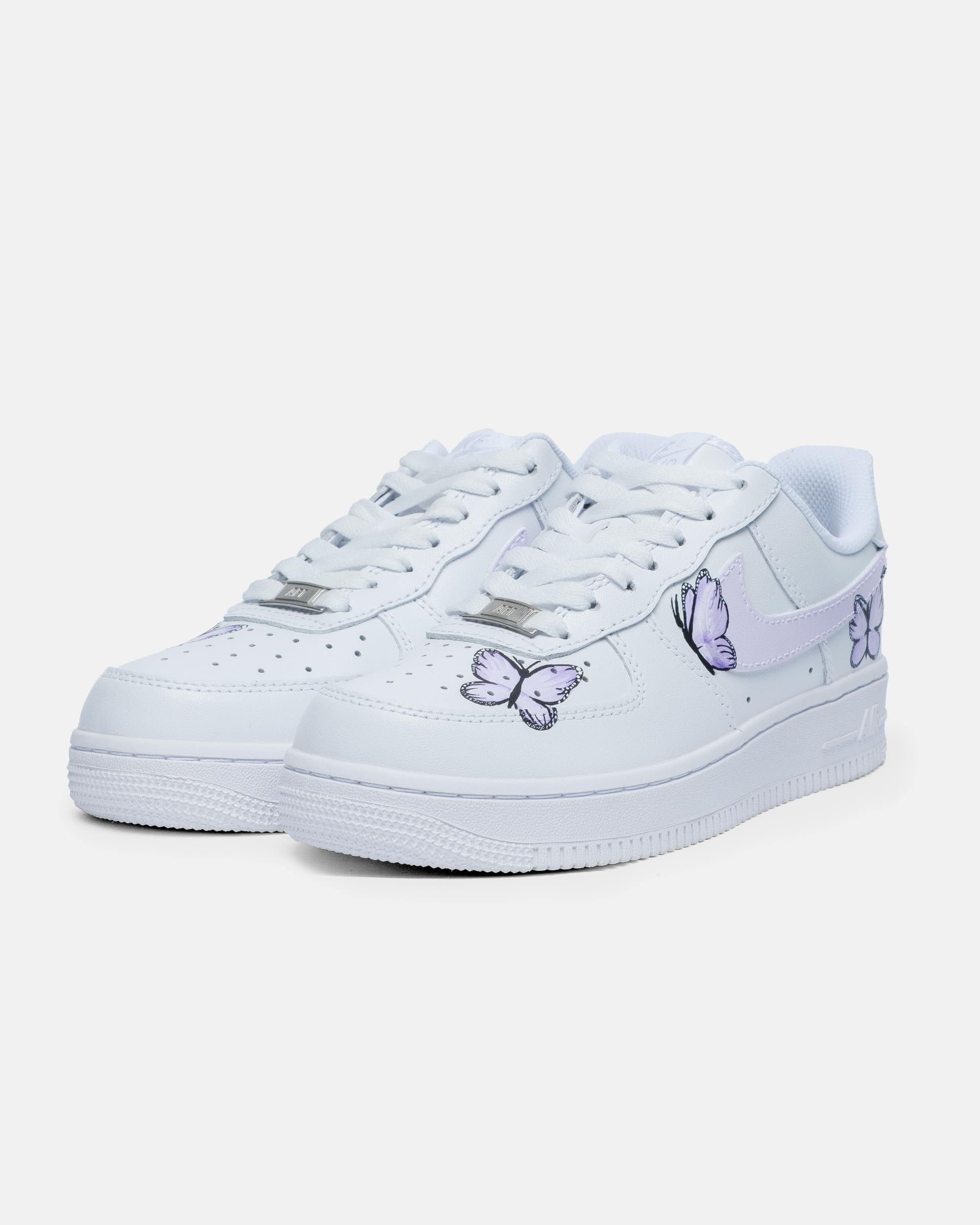 Side view of hand-painted custom Air Force 1 sneakers adorned with purple butterflies, showcasing a unique and artistic design
