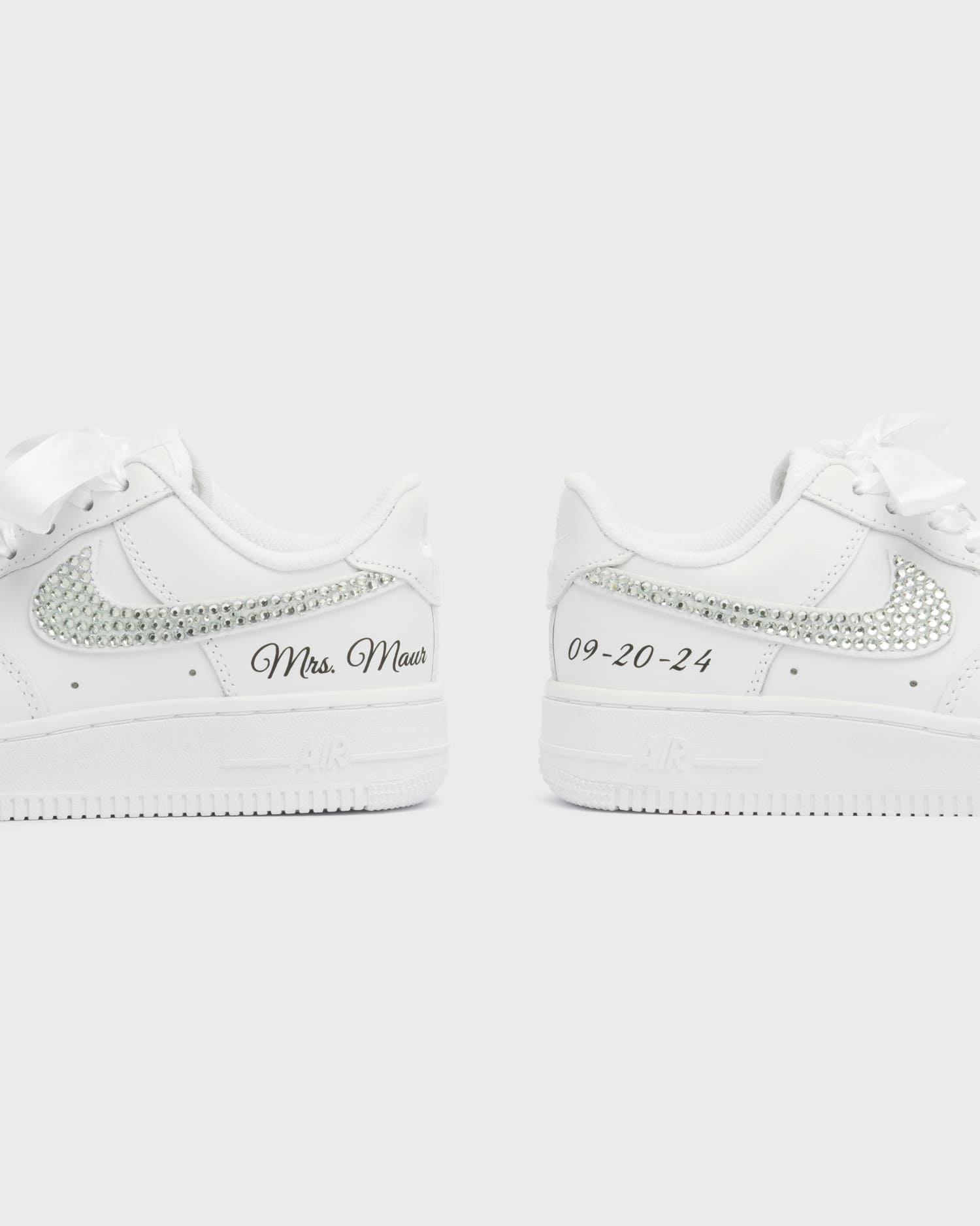 Personalized white Air Force 1 wedding sneakers with rhinestone swoosh, 'Mrs. Maur' embroidery, and custom wedding date '09-20-24'. Handcrafted bridal shoes with satin laces for a special occasion.