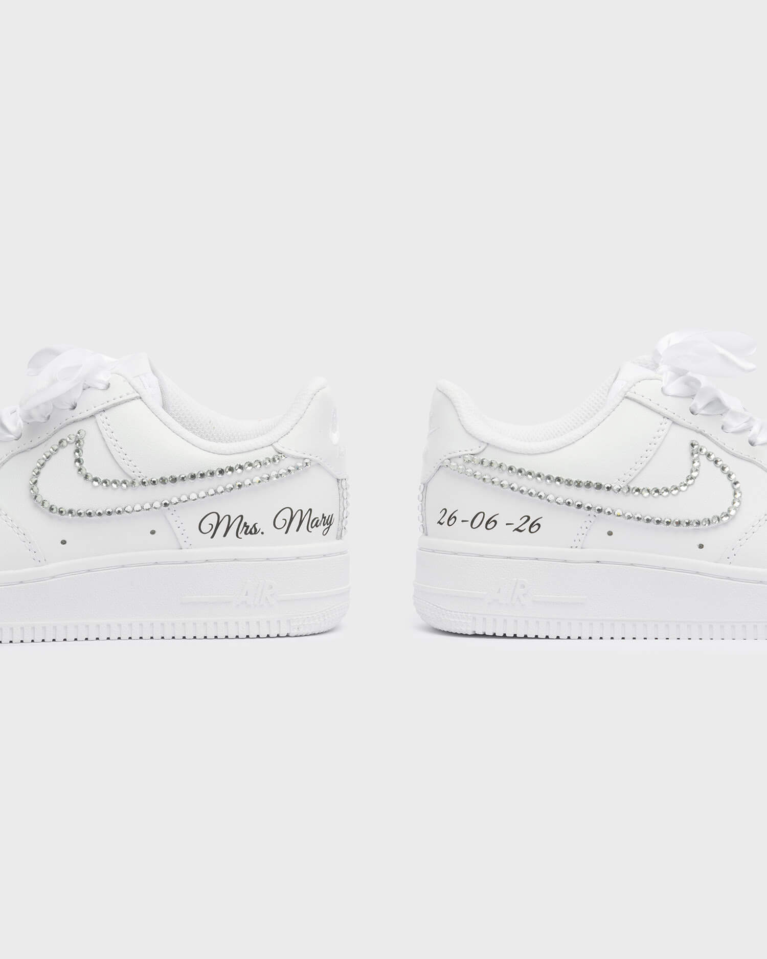 Personalized white Air Force 1 wedding sneakers with rhinestone details, 'Mrs. Mary' embroidery, and custom wedding date '25-02-25'. Elegant handcrafted bridal sneakers for a unique wedding look.