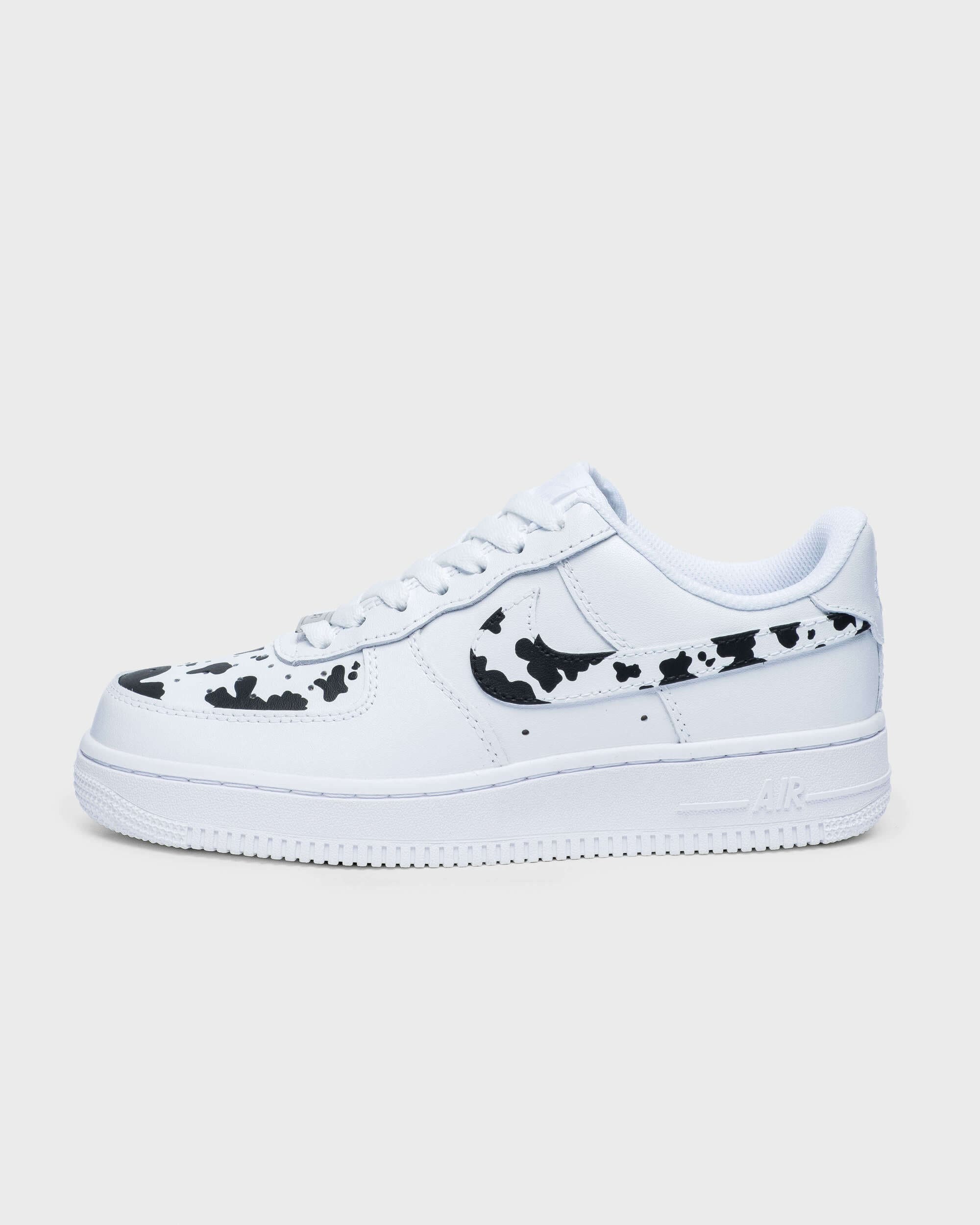 Side profile of custom Air Force 1 sneaker featuring a hand-painted cow print design, ideal for a unique personalized style.