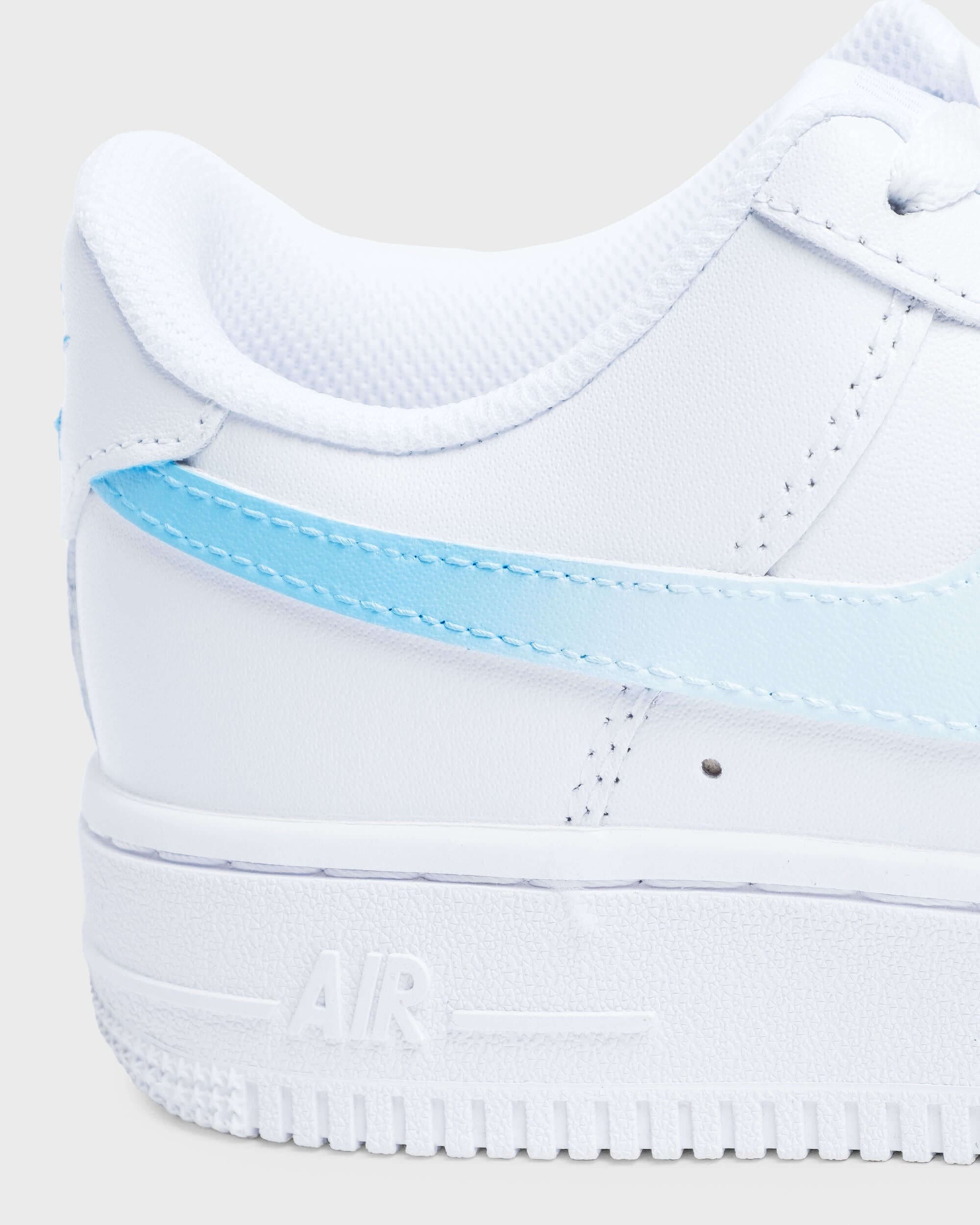 Close-up of custom Air Force 1 sneaker with a light blue swoosh on a white leather base, highlighting the clean and smooth design for a fresh, personalized look.