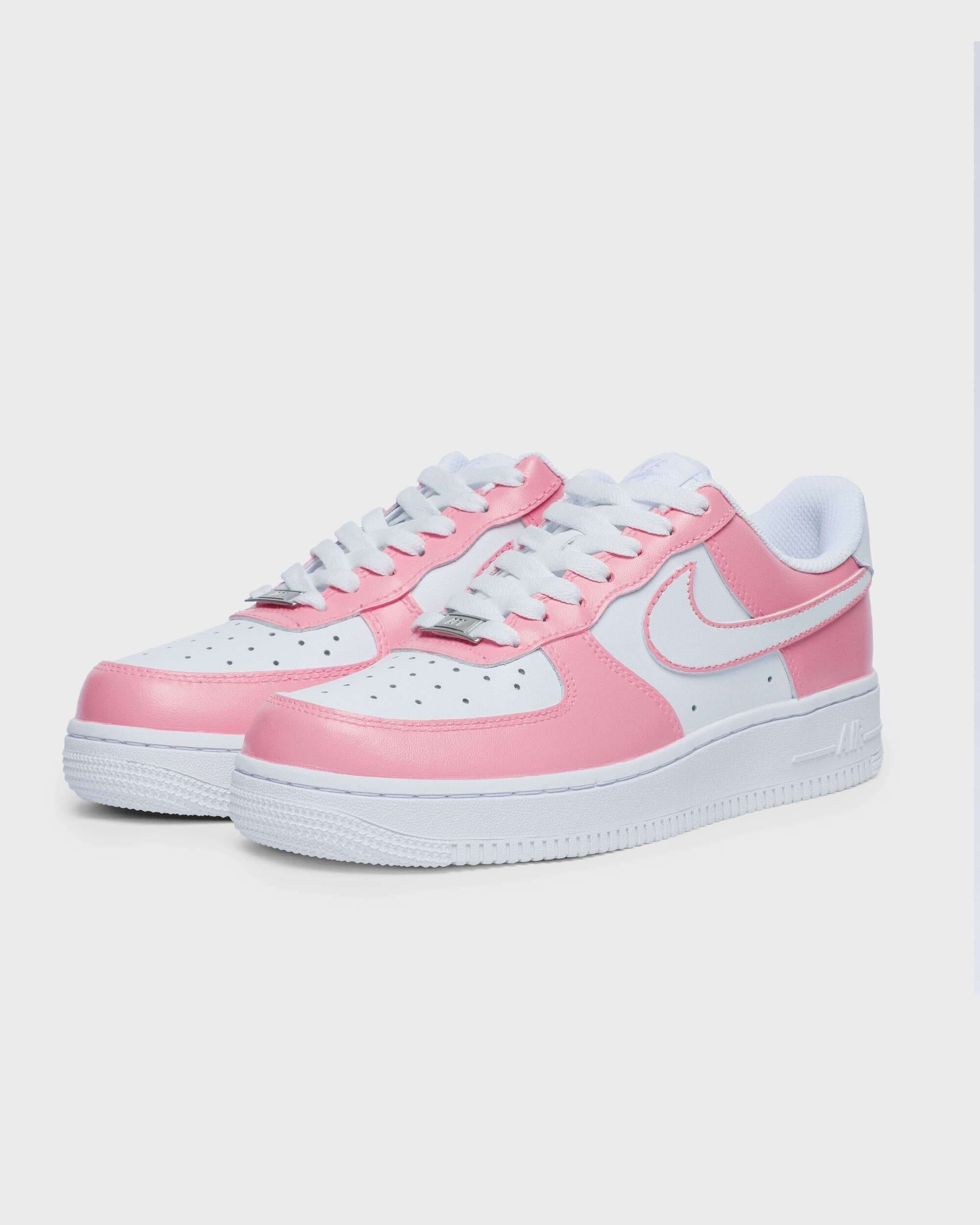 Side angle of custom pink Air Force 1 sneakers – highlighting the vibrant pink panels and signature white Nike swoosh.