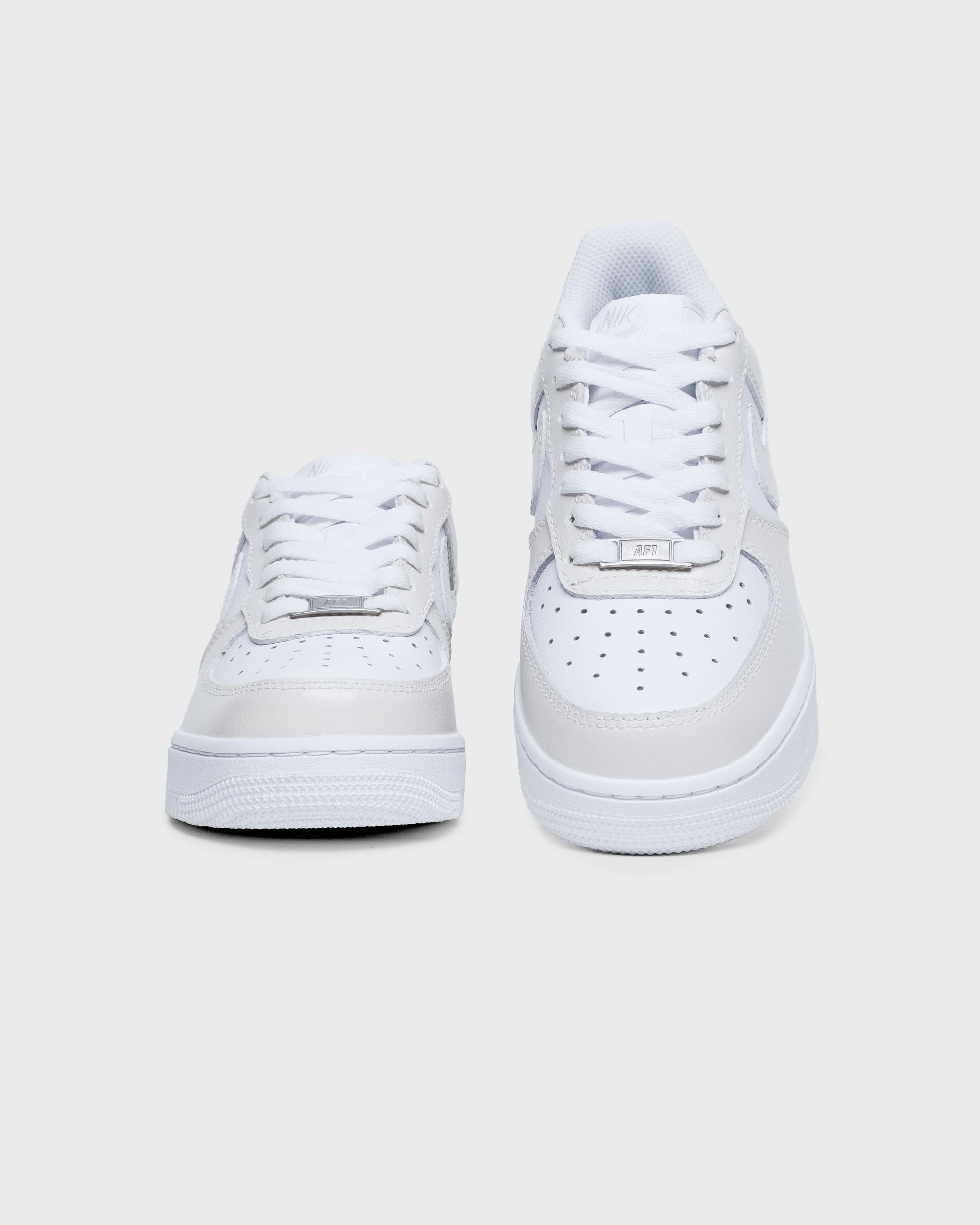 Front view of custom Air Force 1 sneakers in a soft cream color, offering a sleek and personalized look.