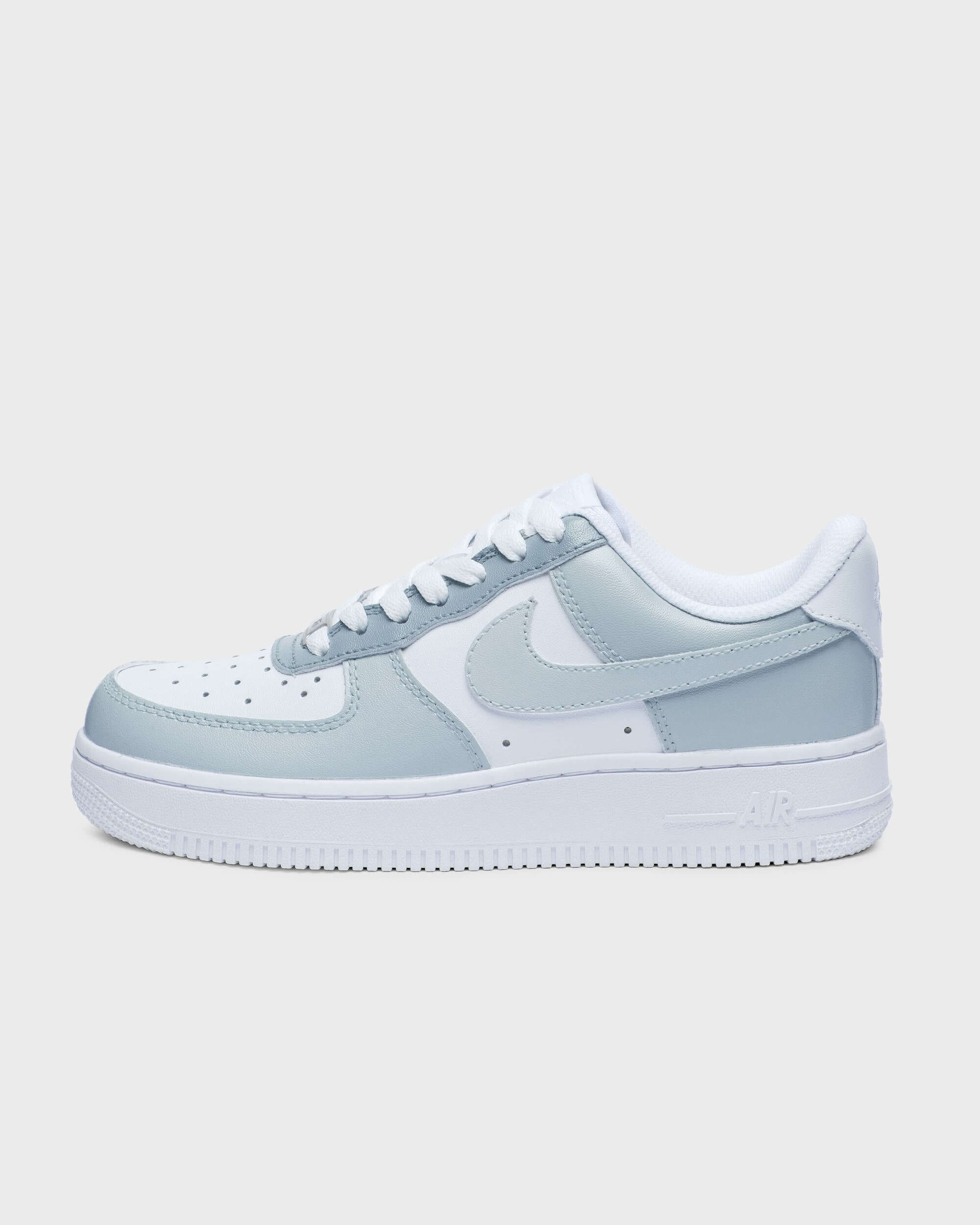 Side profile of custom Air Force 1 sneaker with light gray overlays on a white base, ideal for a clean, minimalist aesthetic and personalized style.