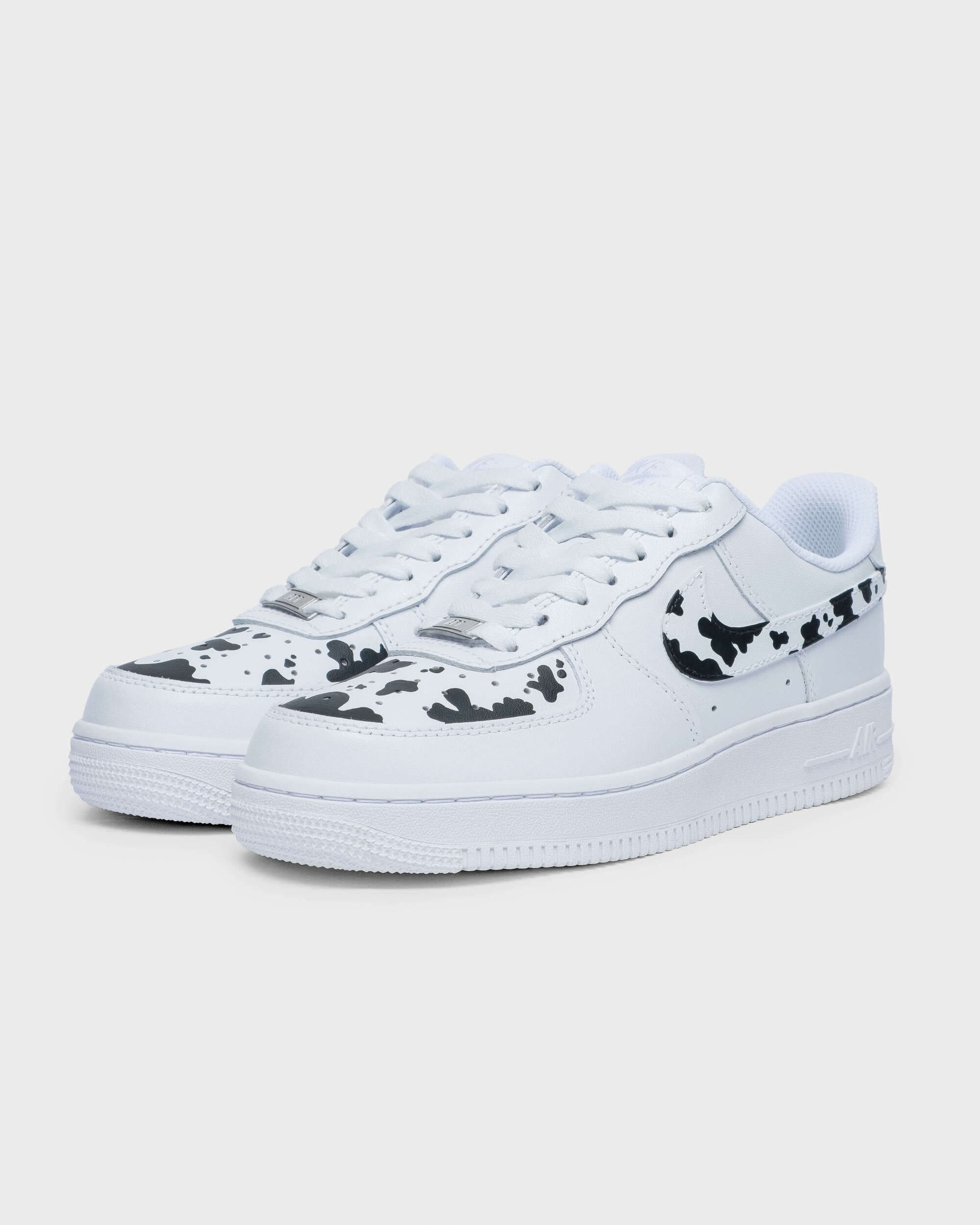 Angled view of custom Air Force 1 sneakers with unique cow print design, perfect for a personalized look.