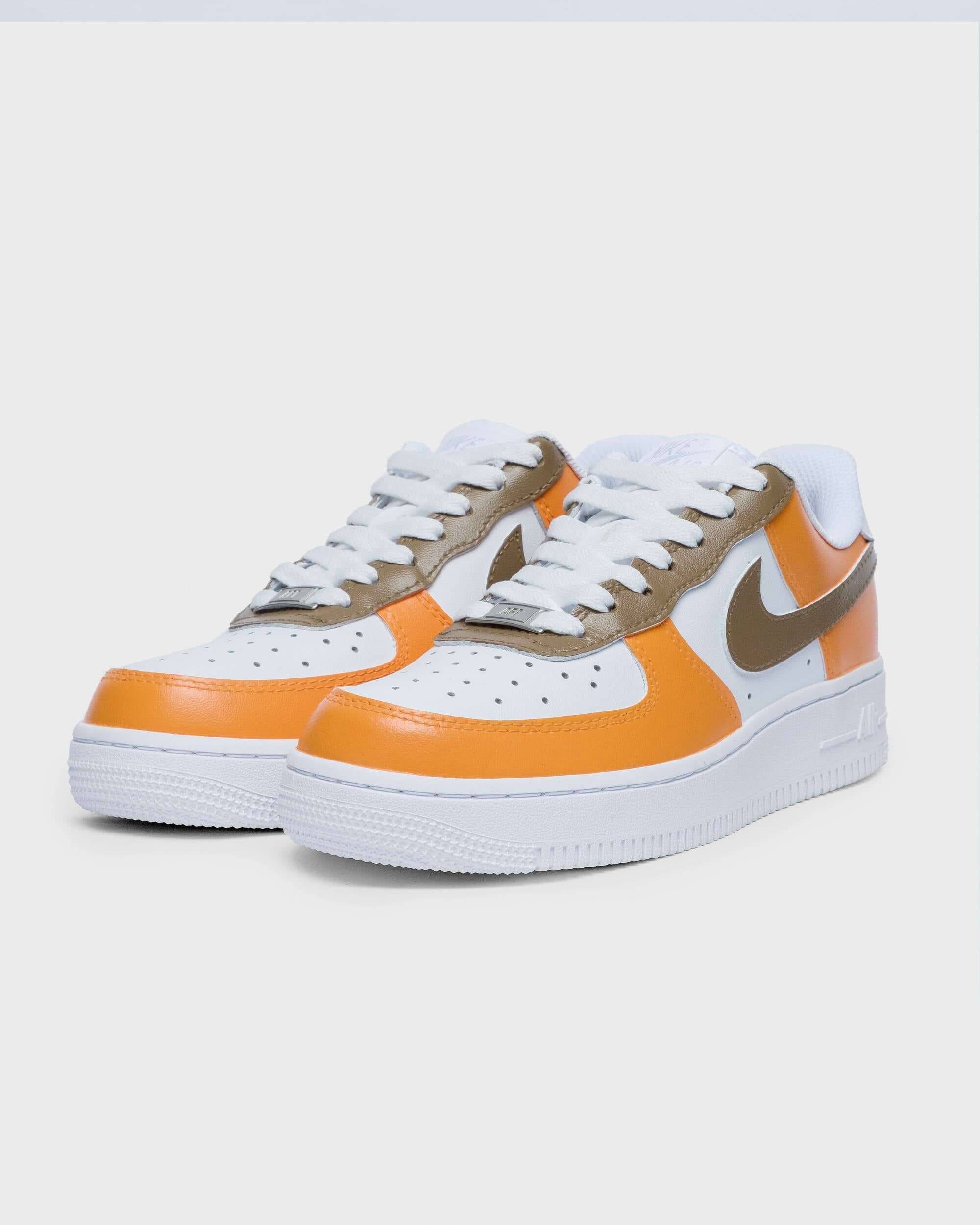 Side view of custom Air Force 1 sneaker with orange overlays and a brown swoosh, creating a unique, bold design perfect for a fresh style statement.