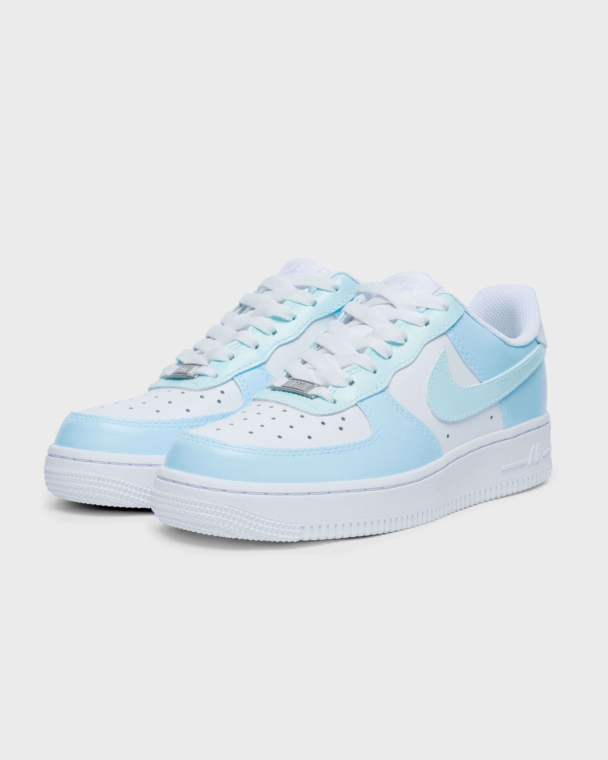 Side view of custom Air Force 1 sneaker featuring a soft blue swoosh and light blue overlays, perfect for a trendy, minimalist look.