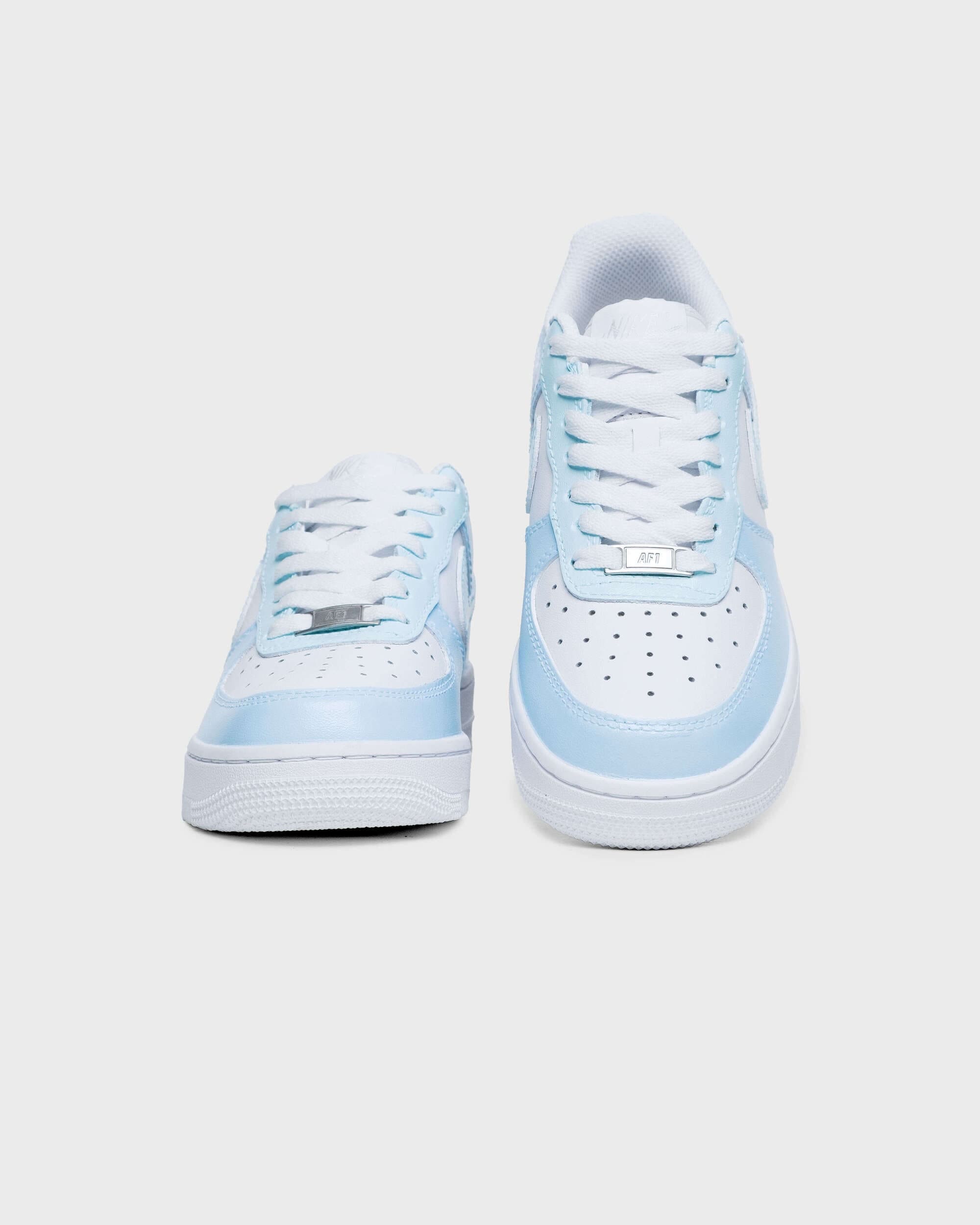 Front view of custom Air Force 1 sneakers with light blue accents and perforated toe box, creating a fresh, modern style.