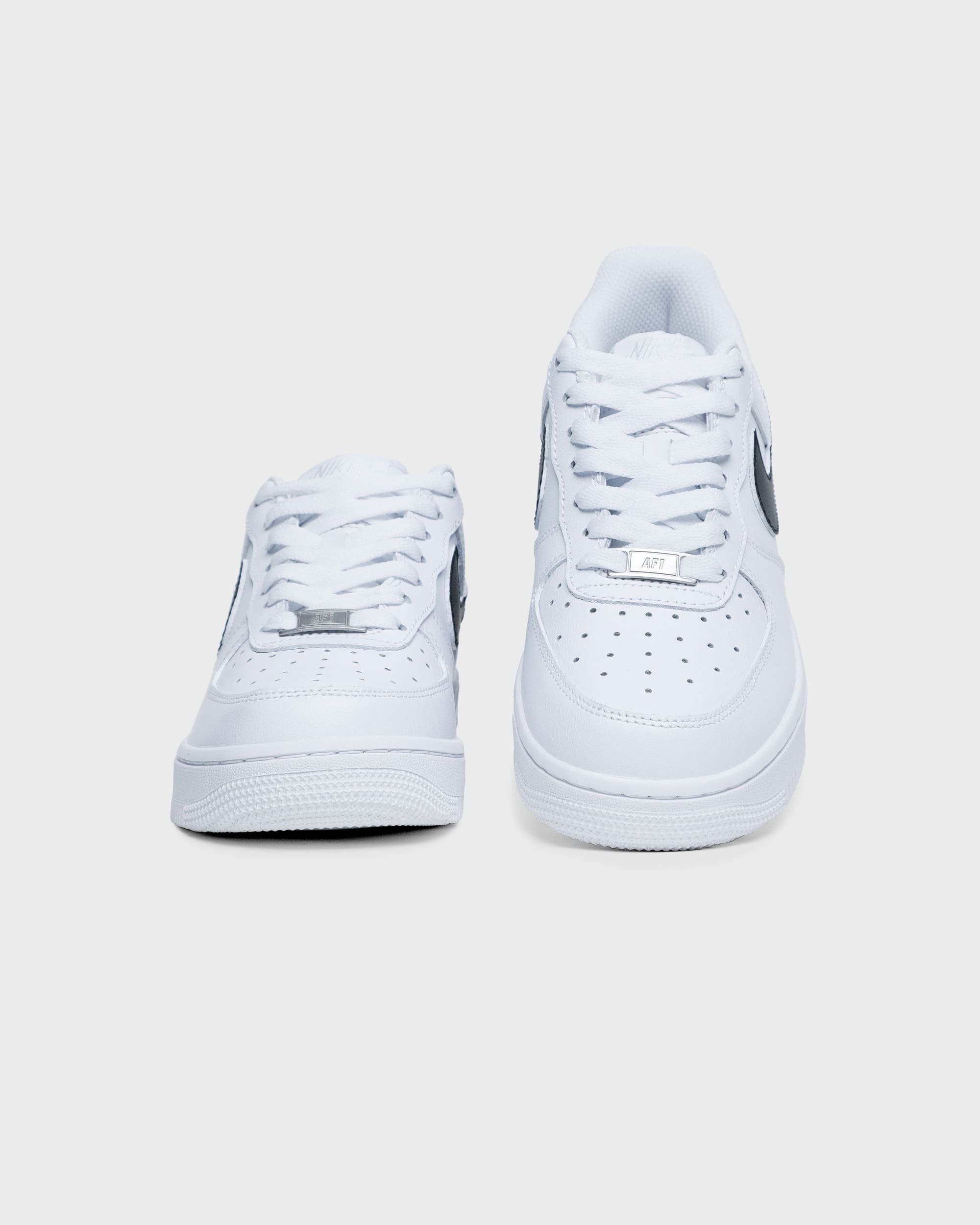 Custom white Nike Air Force 1 sneakers with a black swoosh, front view showing detailed lacing and sleek design.