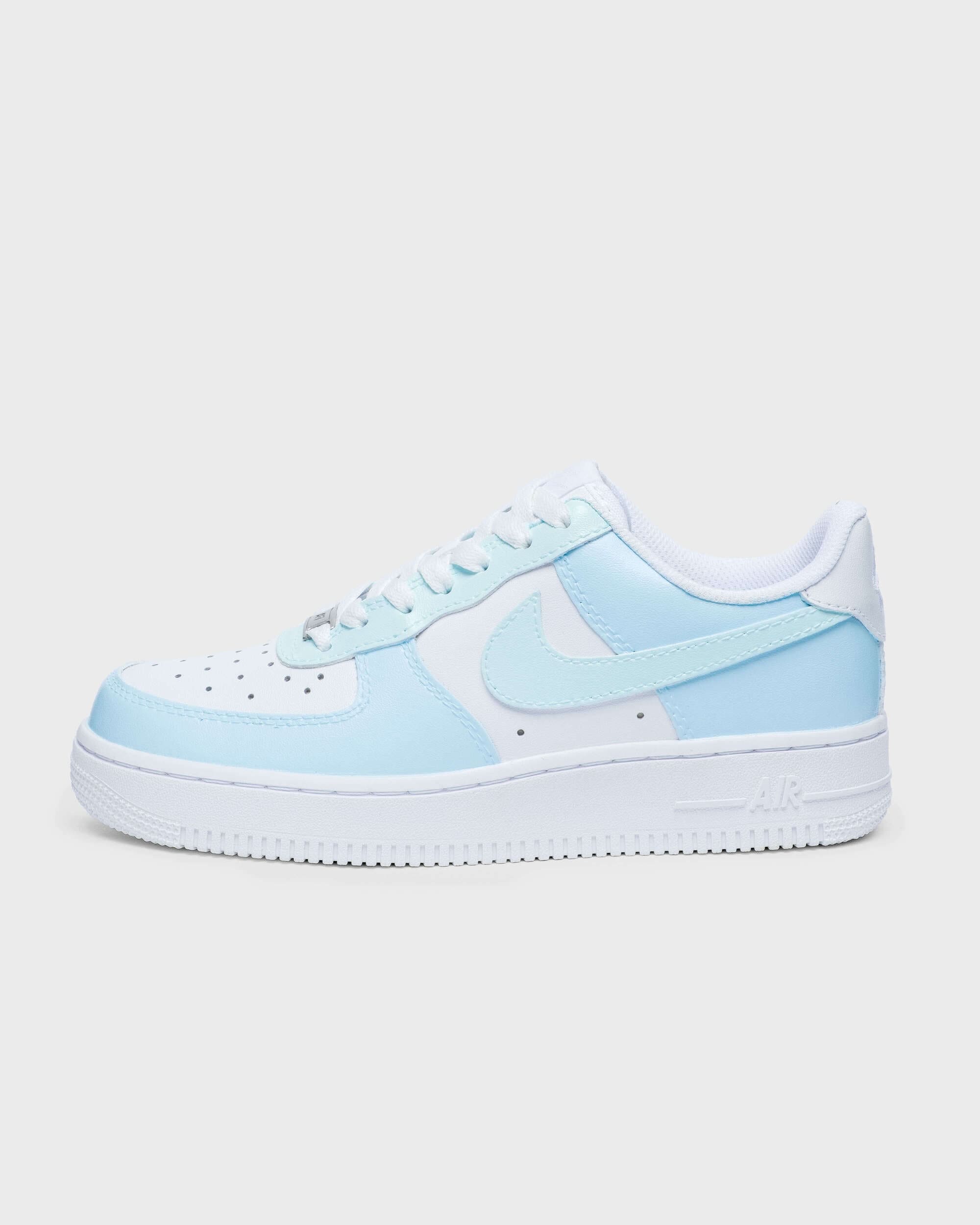 Side profile of custom Air Force 1 sneaker with light blue accents on a white base, ideal for a soft and stylish, personalized look.