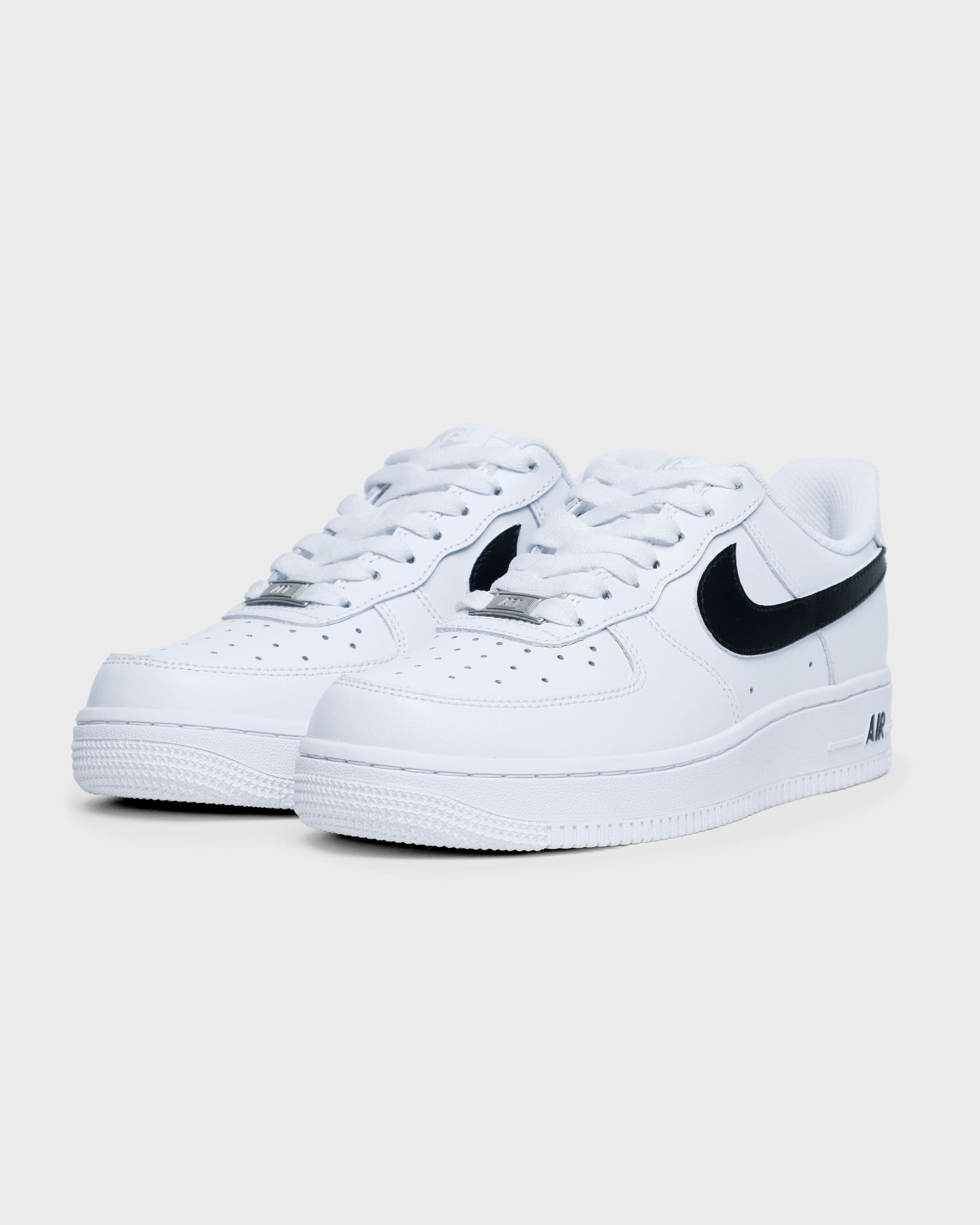 Personalized Nike Air Force 1 shoes in white with a black swoosh, angled side view highlighting the iconic design and custom look.