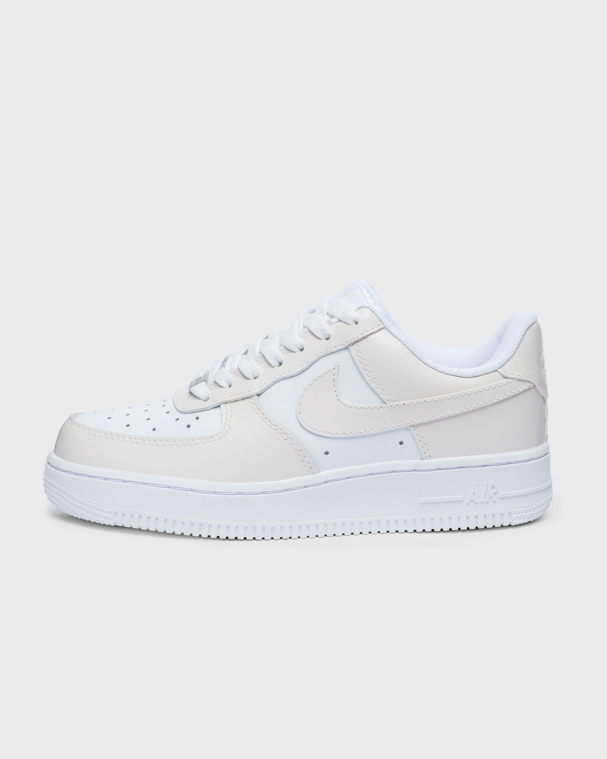 Side profile of custom Air Force 1 sneaker in cream with a minimalist design, perfect for a personalized touch.