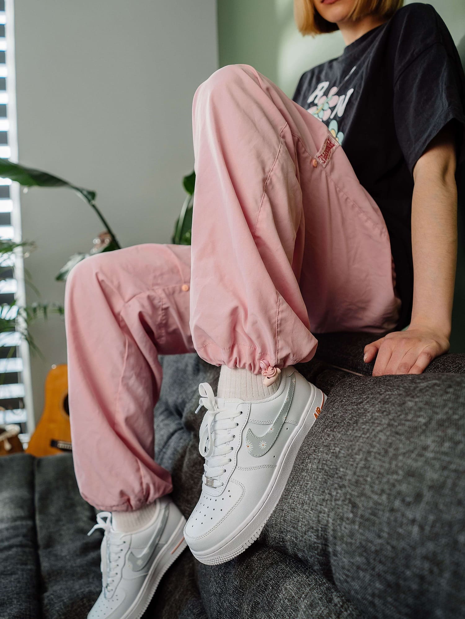 Close-up of custom Air Force 1 sneakers with floral design on model, highlighting the hand-painted flower details.